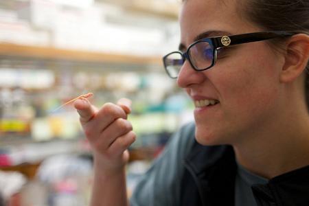 Ashley Rasys holds one of the lizards on her fingertip.